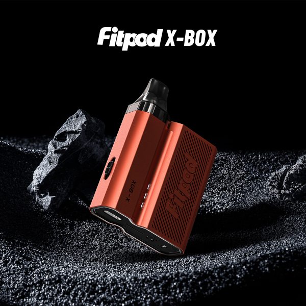 橘色款 FITPOD X-BOX 主機在礦石紋理背景中展示，金屬質感與細節清晰可見
